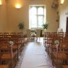Notley abbey wedding venue ceremony pedestal chair pew end flowers 1
