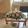 Notley Abbey wedding venue ceremony registrar table flower arrangement blus