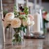 The Great Barn Aynho venue wedding aisle and guest table centre piece vases
